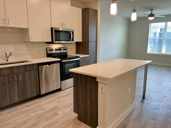 Kitchen island with pendant lighting and open layout at Bridge at Windsor Park Apartments, Austin
