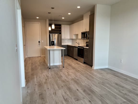 Open concept living area with kitchen island at Bridge at Windsor Park Apartments, Austin