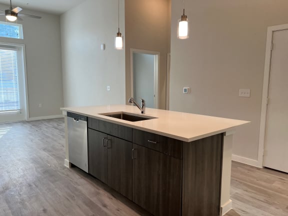 Kitchen island with undermount sink and dishwasher at Bridge at Windsor Park Apartments, Austin, TX 78723