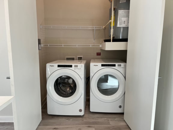Laundry closet with front load washer and dryer at Bridge at Windsor Park Apartments, Austin, TX