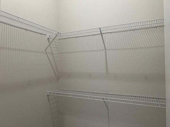 Walk-in closet with wire shelving and corner layout at Bridge at Windsor Park Apartments, Austin, Texas