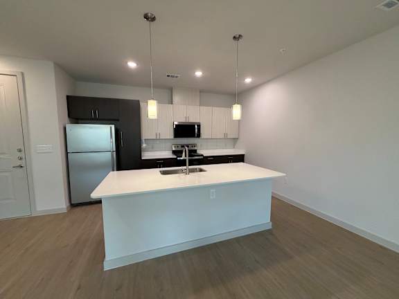 A white kitchen island with a countertop and a sink.