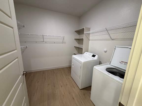 A small laundry room with a washer and dryer.