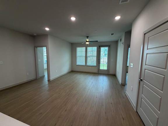 A room with wooden floors and white walls.