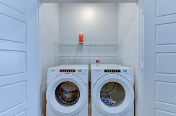 Inunit laundry room with front load washer and dryer at Matador Apartments, Texas