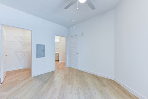 A room with a white ceiling and a wooden floor. at Park South Apartments, Austin, TX, 78748