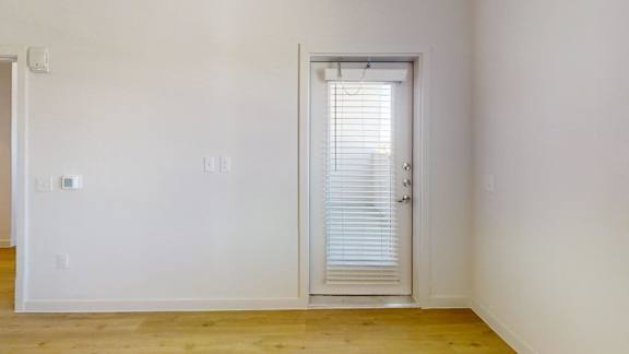 A room with a door and a window.