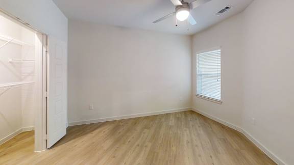 A room with a white door and a window with blinds. at Park South Apartments, Austin