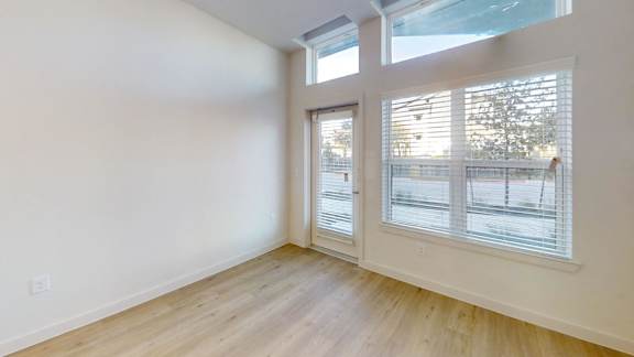 A room with a sliding glass door and a window. at Park South Apartments, Texas, 78748