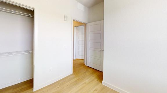 A white door is in a white room.
