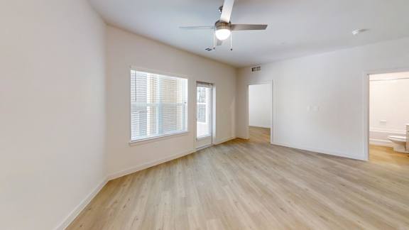 A room with a ceiling fan and a window with blinds. at Park South Apartments, Texas, 78748