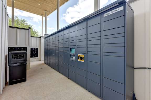 A large blue storage unit with a black oven in front of it.
