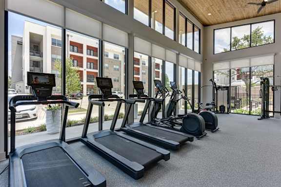 A gym with treadmills and exercise equipment.