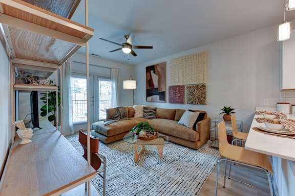 Furnished living and dining area with sectional sofa at Bridge at Saffron Apartments, Austin, 78717