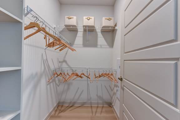 Walk-in closet with wire shelving and hangers at Bridge at Saffron Apartments, Austin, TX