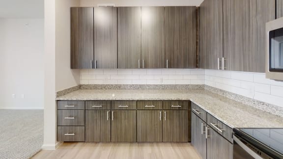 a kitchen with wood cabinets and granite countertops at Avery Ranch, Austin, 78717
