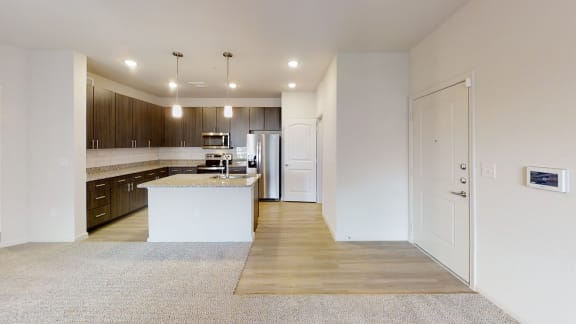 a kitchen and living room with white walls and wood floors at Avery Ranch, Austin Texas
