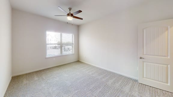 a bedroom with white walls and a ceiling fan at Avery Ranch, Austin