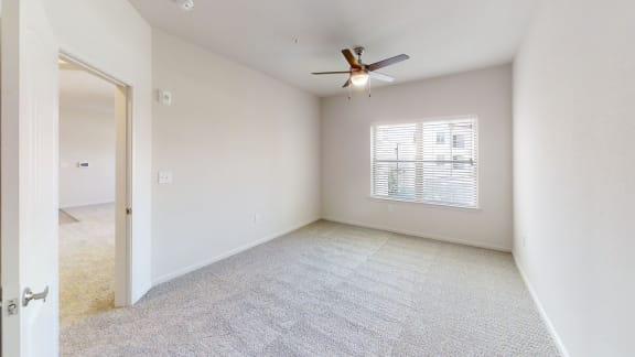 a bedroom with white walls and a ceiling fan at Avery Ranch, Austin Texas