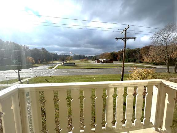 A view from a balcony overlooking a street.