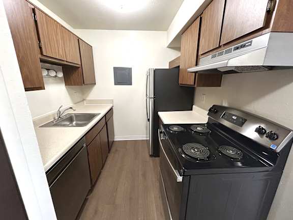 A kitchen with a black refrigerator and stove.