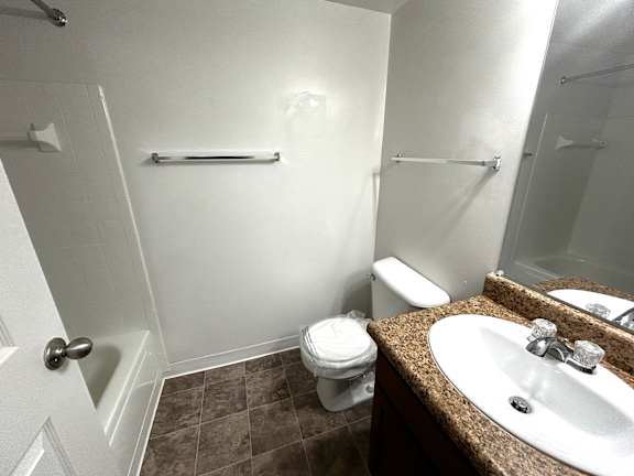 Bathroom with granite vanity and towel bar at Charter Oaks Apartments, Michigan