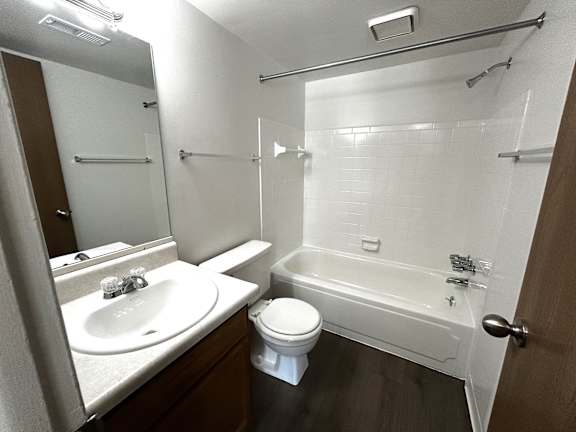 A white sink and toilet in a small bathroom.