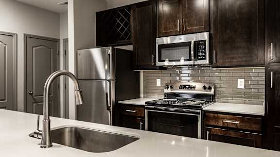 a kitchen with stainless steel appliances and a sink at Bella Vista Apartments, Indiana