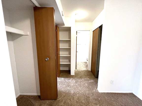 Hallway with built in shelving and multiple doorways at Charter Oaks Apartments, Davison, 48423