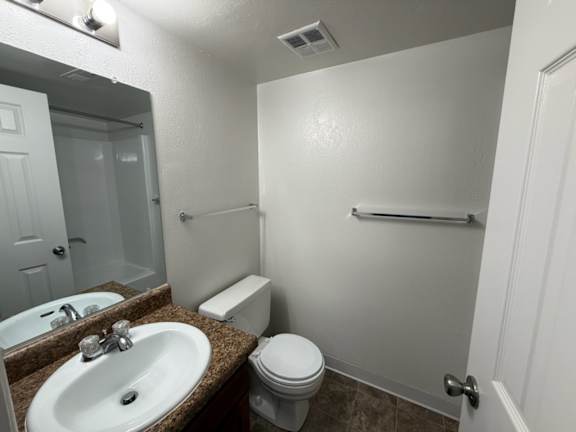 a bathroom with a sink toilet and a mirror