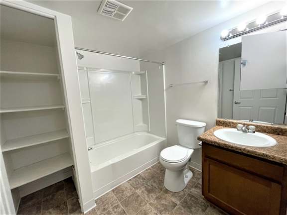 Bathroom with builtin shelving and tub shower combo at Charter Oaks Apartments, Michigan, 48423