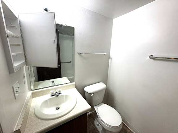 A white bathroom with a toilet and sink.