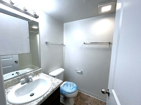Bathroom with granite vanity and shower tub area at Charter Oaks Apartments, Davison, Michigan