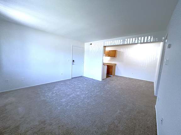 Loft studio with upper level railing and kitchenette at Charter Oaks Apartments, Davison, Michigan