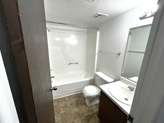 Bathroom with soaking tub and glass shower door at Charter Oaks Apartments, Michigan, 48423