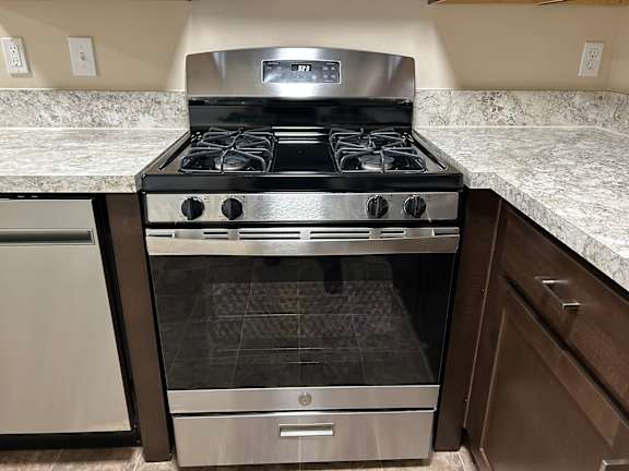 A modern kitchen with a stainless steel oven and a dishwasher.
