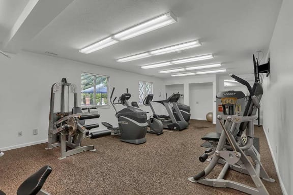 a gym with treadmills and other exercise equipment  at Polo Run Apartments, Greenwood