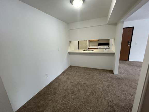 Dining room with open kitchen pass through window at Charter Oaks Apartments, Michigan, 48423