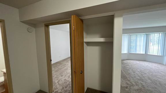 Open closet with shelf and view into carpeted room at Charter Oaks Apartments, Michigan, 48423