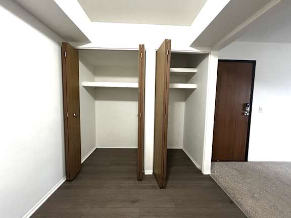 Two open walkin closets with upper shelving at Charter Oaks Apartments, Davison, 48423