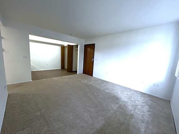 Open living room with hallway and entry door at Charter Oaks Apartments, Davison, 48423