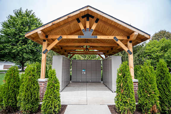A wooden covered walkway leads to a garages at Towne Lakes Apartments, Grand Chute, 54913