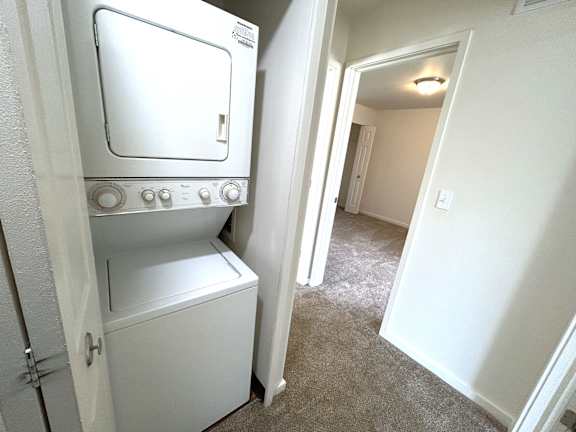 A white oven and dishwasher in a small room.