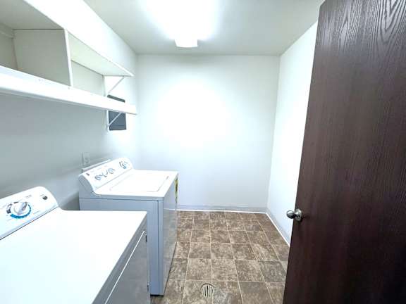 A spacious laundry room with a washer and dryer.