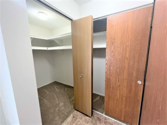Walk-in closet with shelving and sliding doors at Charter Oaks Apartments, Michigan