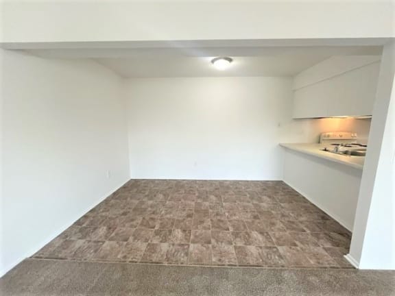 Finished basement with vinyl flooring and built in shelving at Charter Oaks Apartments, Davison