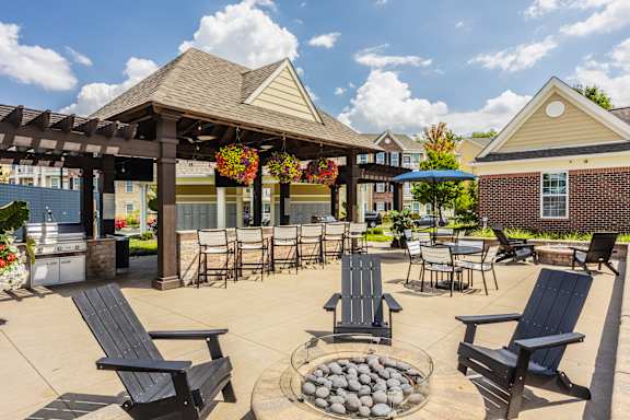A patio area with a fire pit and seating.