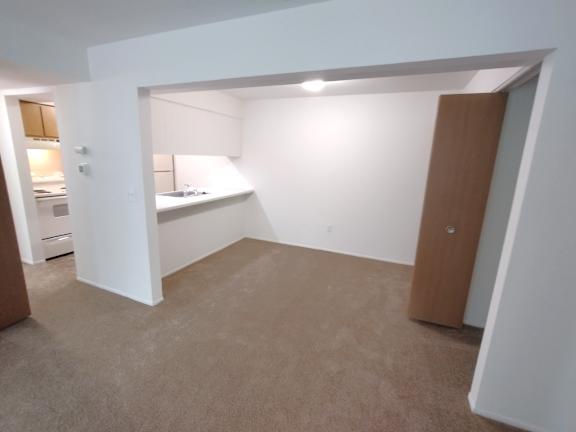 Open layout with kitchenette and carpeted floor at Charter Oaks Apartments, Davison, MI, 48423