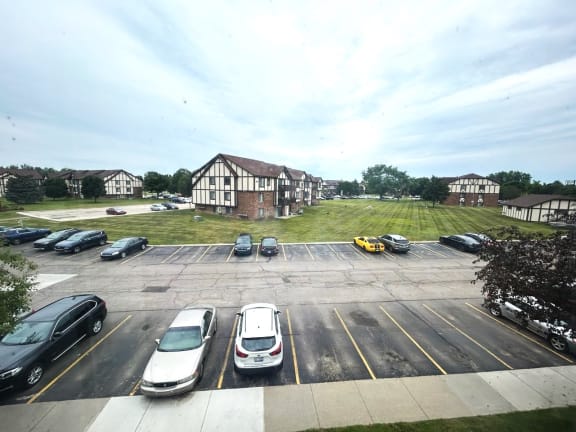 Parking lot with tudor style residential buildings at Charter Oaks Apartments, Davison