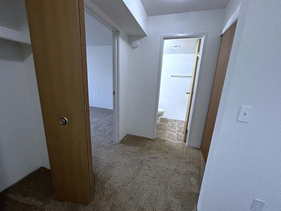 Hallway view with bathroom entrance and connecting rooms at Charter Oaks Apartments, Davison